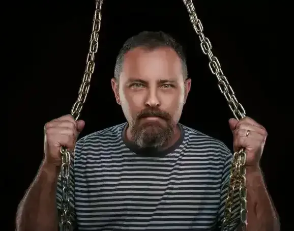 Photographer Scot holding chains in studio